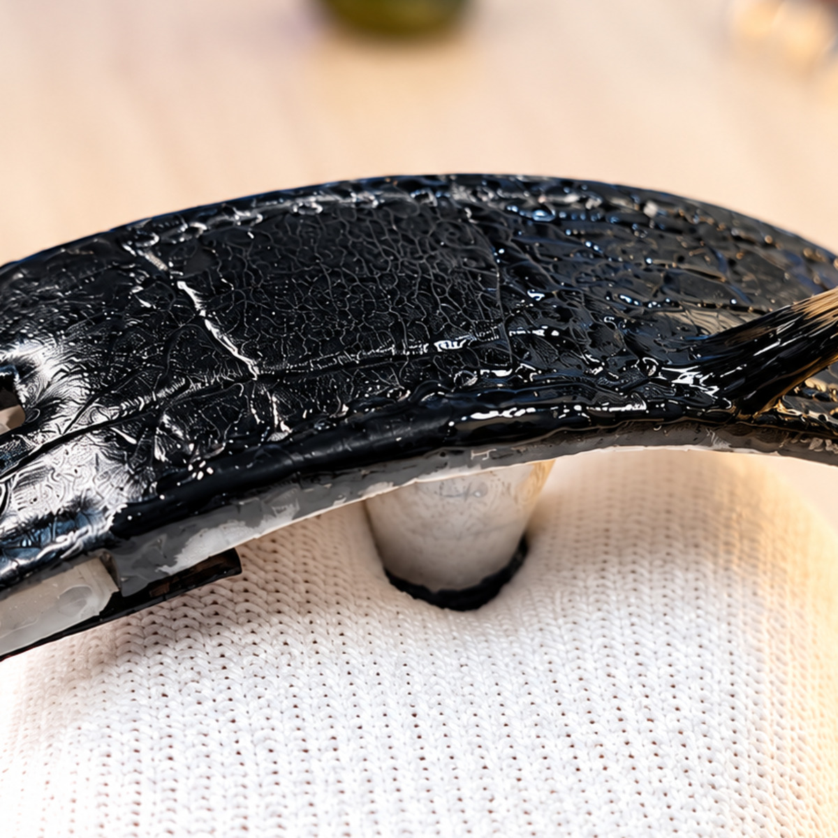 Restoring black colour and finish on the strap surface.